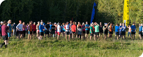 Runners wait in grassy field to start the race